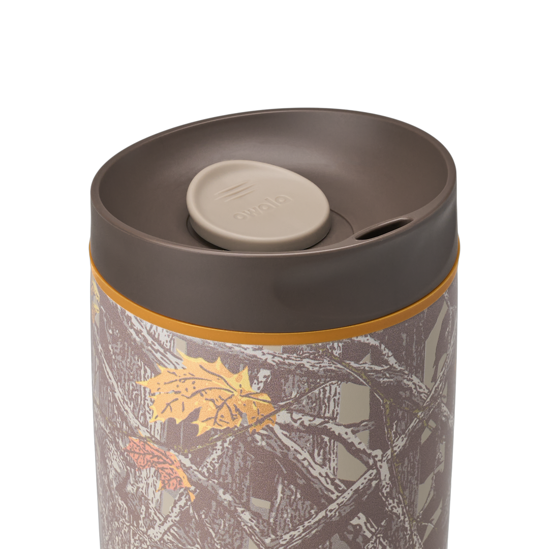 Owala SmoothSip Slider 20oz in Out of Sight, lid close-up showing dark brown lid with tan slider button and orange accent ring at the lid base